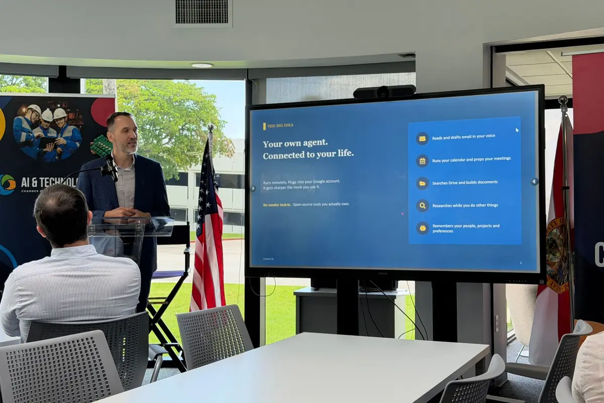 Brian Schmitt presenting at the Chamber of Commerce of the Palm Beaches, beside a slide titled Your own agent. Connected to your life.